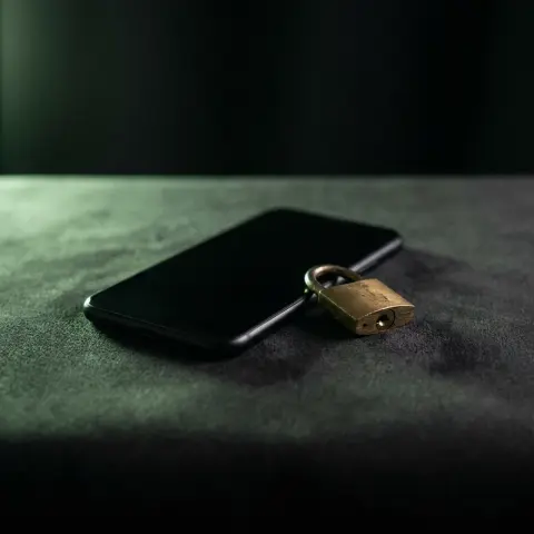 A phone face down beside a closed padlock